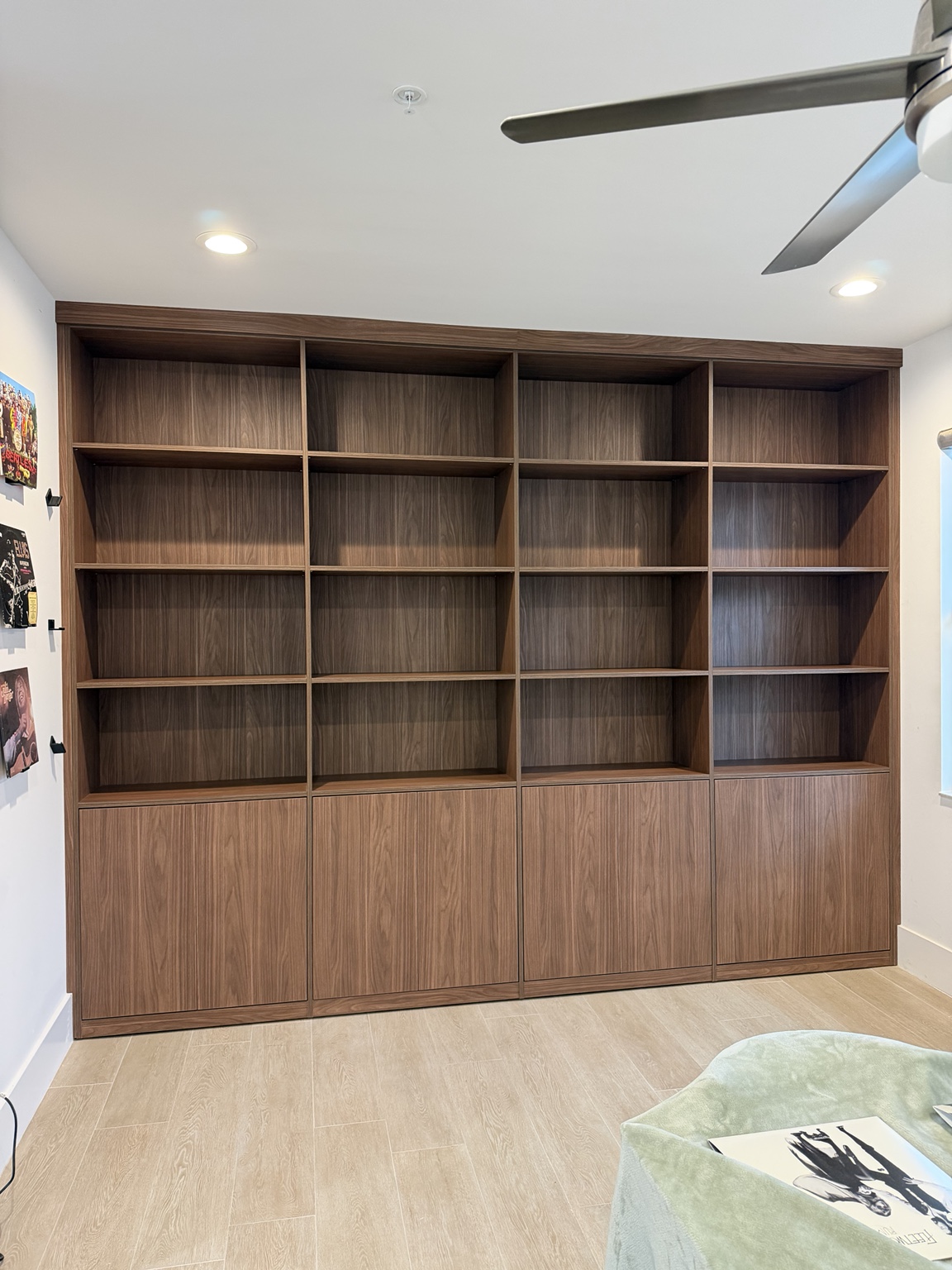 Wall-to-wall walnut shelving and concealed cabinetry